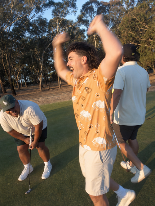 Mates celebrating a putt in the Beverage Cart VIP polo